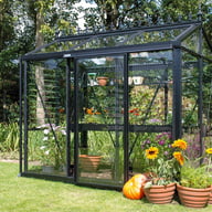 Janssens Helios Urban black greenhouse in a garden