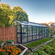 Janssens Master Victorian black greenhouse in a garden
