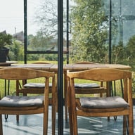 Dining inside a Janssens Modern pent roof greenhouse