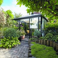 Janssens Pyramide black orangery greenhouse in a garden