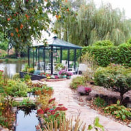 Janssens Pyramide green orangery greenhouse in a garden