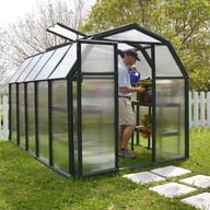 Palram Canopia Eco Grow 6x10 Green greenhouse front lifestyle photograph