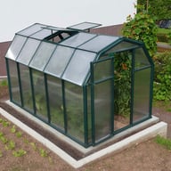 Palram Canopia Eco Grow 6x10 Green greenhouse elevated lifestyle photograph