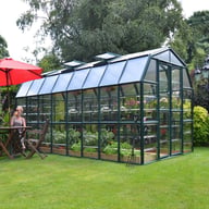 Palram Canopia Grand Gardener 8x16 Green greenhouse side lifestyle photograph