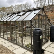 Elite Titan 700 14x7 greenhouse installed in a walled garden with water butts