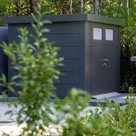 Telluria metal garden shed installed in a garden