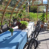 Norhage Tre 300 wooden polycarbonate greenhouse interior arranged for a dining event