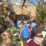Norhage Tre 300 wooden polycarbonate greenhouse interior used for a community workshop