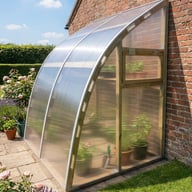 Gable end of the Norhage Lite Vegg 150 lean-to greenhouse showing the curved roof and opening window
