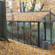 Black Janssens Master greenhouse in an autumn garden