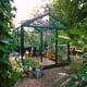 Inside a Janssens Senior green greenhouse with plants