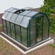 Palram Canopia Eco Grow 6x10 Green greenhouse elevated lifestyle photograph