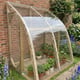 Norhage Lite Vegg 150 wooden lean-to greenhouse planted with tomatoes and herbs in a cottage garden border