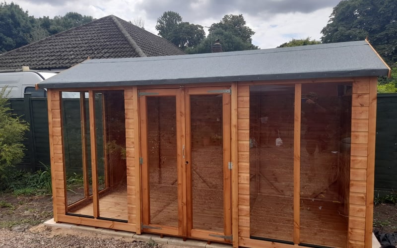 Wooden potting shed and greenhouse combi building on a gravel base