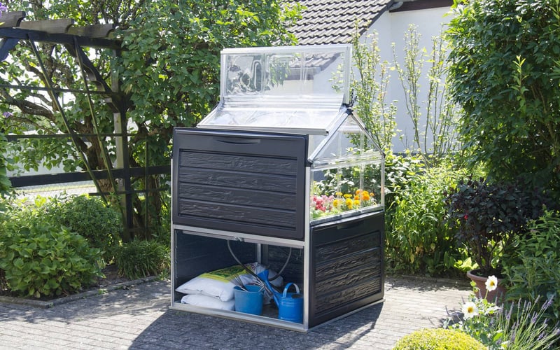 Palram Canopia Plant Inn raised cold frame sheltering flowers in a UK garden in autumn