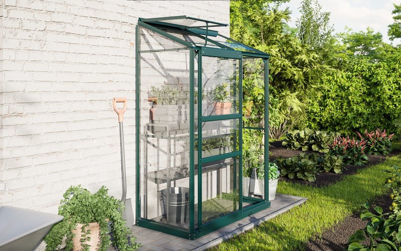 Vitavia IDA lean-to greenhouse fitted against a wall in a small UK garden