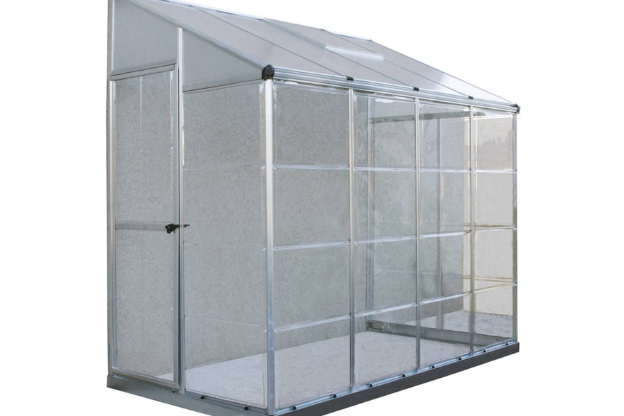 Palram Canopia 8x4 Lean to Greenhouse with clear polycarbonate glazing against a wall